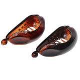 Two brown hair clips with 'Parcelona' branding on a white background, featuring text about product features.