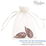 Two Banana hair clips in a free sheer drawstring bag with 'Parcelona' branding.