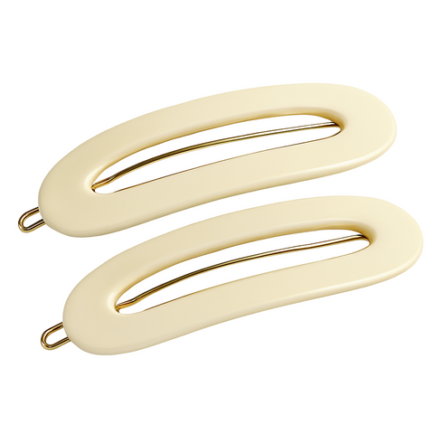 Two Ivory-colored hair clips with gold hardware on a white background