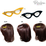 Three hair clips shaped like glasses on a white background with 'Parcelona' branding.