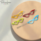 Colorful hair clip sunglasses on a beige surface with 'Parcelona' branding.