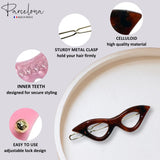 Cat-eye hair clip with features highlighted on a gray background