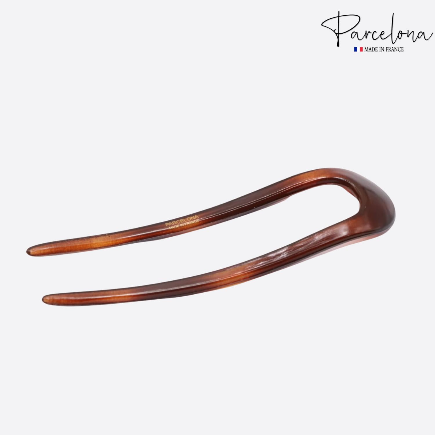 Brown hair comb on a white background with 'Parcelona' branding.