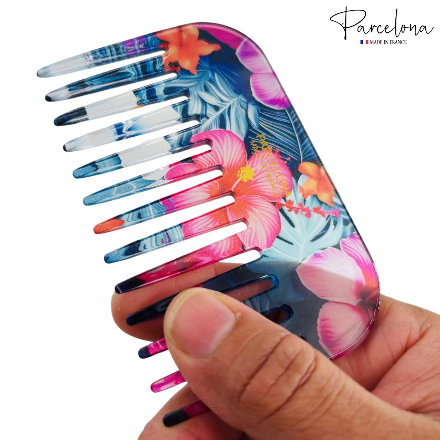 Colorful floral comb held by a hand with 'Parcelona' branding.