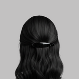 Black hair clip in a person's hair on a gray background