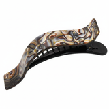 Decorative hair clip with a wavy design on a white background