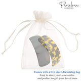 brown and yellow hair accessories in a sheer drawstring bag with 'Parcelona' branding.
