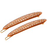 Two rose gold hair clips with crystal embellishments on a white background
