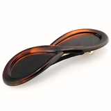 Brown hair clip with a unique design on a white background