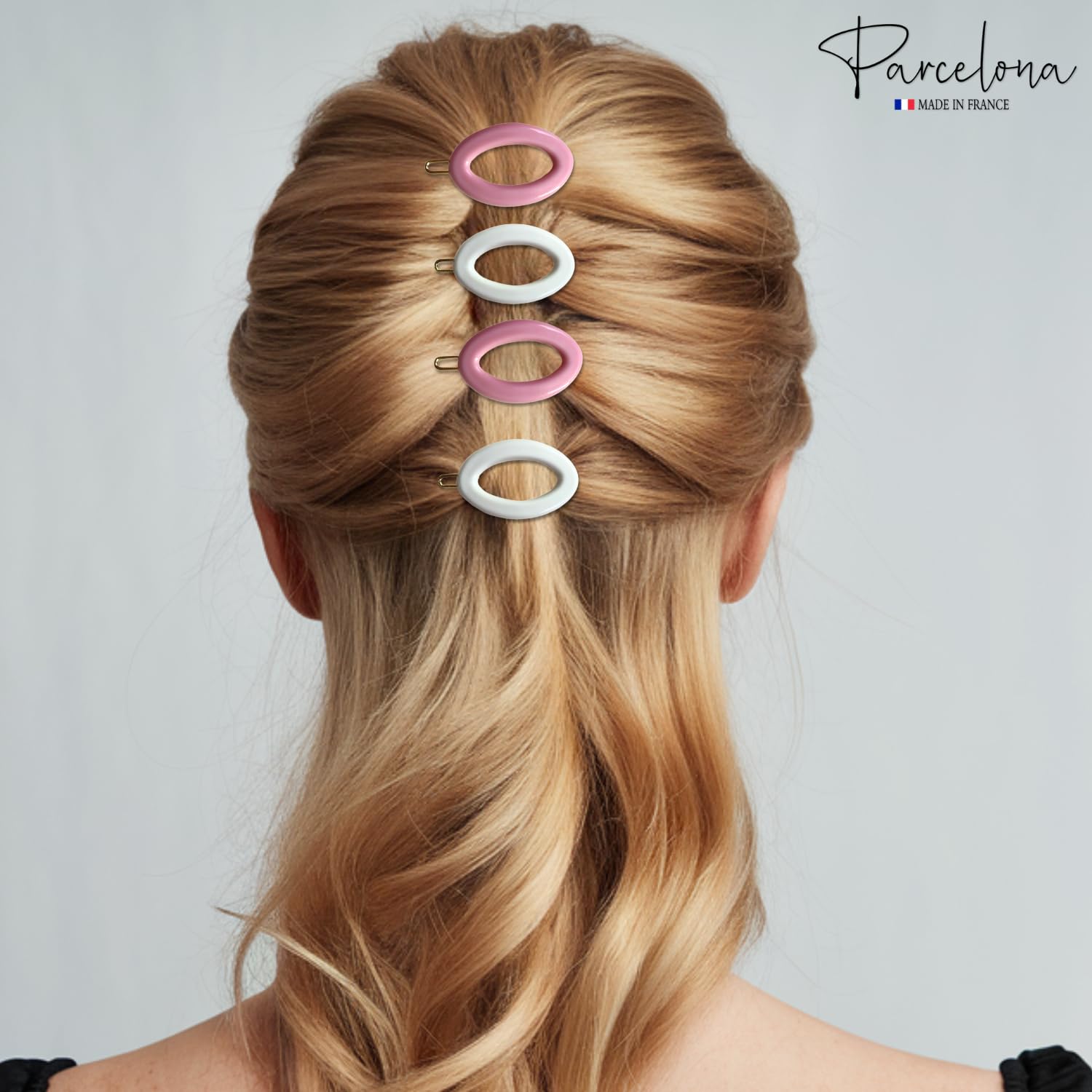 Person with styled hair using pink and white hair clips on a plain background, with 'Parcelona' branding.