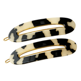 Two patterned hair clips with gold hardware on a white background