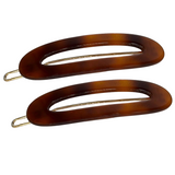 Two tortoiseshell hair clips on a white background