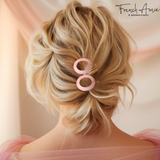 Blonde hair styled with a pink hair clip, featuring 'French Amie' branding.
