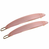 Two pink hair clips with gold hardware on a white background