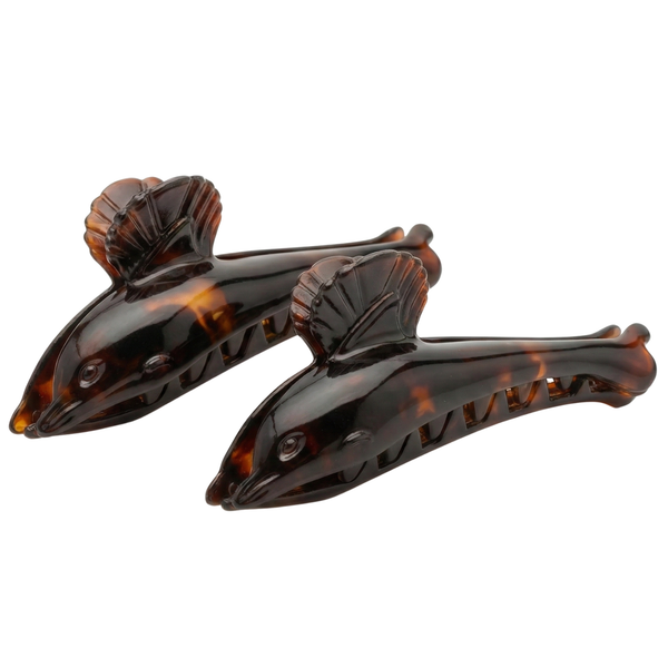 Front view of tortoise-shell dolphin hair claw clip showing carved details and acetate body