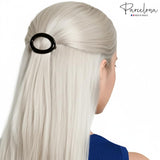 Model with long hair wearing a brown hair clip, with 'Parcelona' branding.