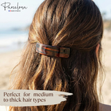 Person with tortoiseshell hair clip in hair, with 'Parcelona' branding and text about hair type compatibility.