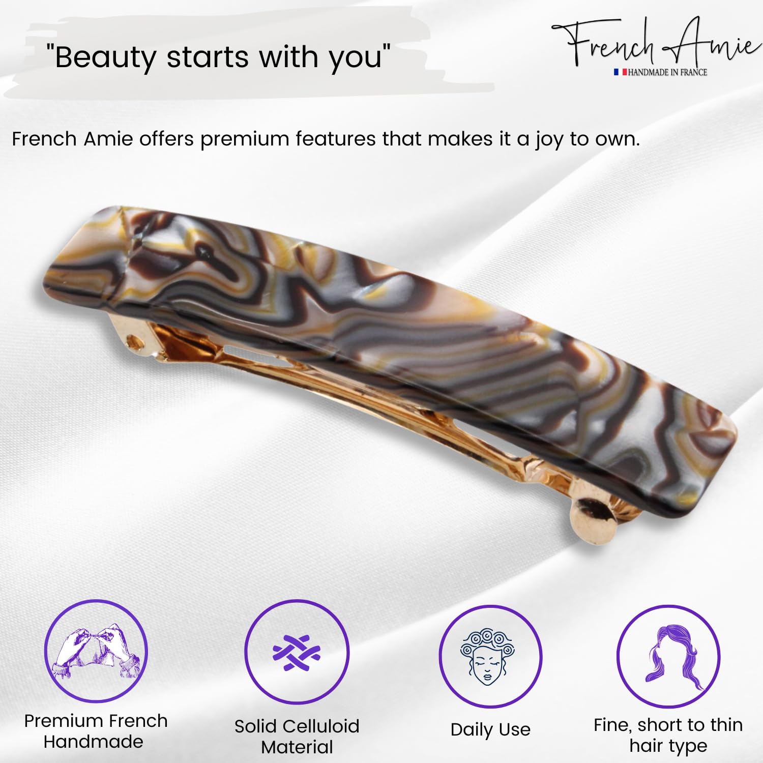 Hair clip with marbled design on a white background, featuring the brand 'French Amie'.
