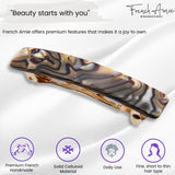 Hair clip with marbled design on a white background, featuring the brand 'French Amie'.