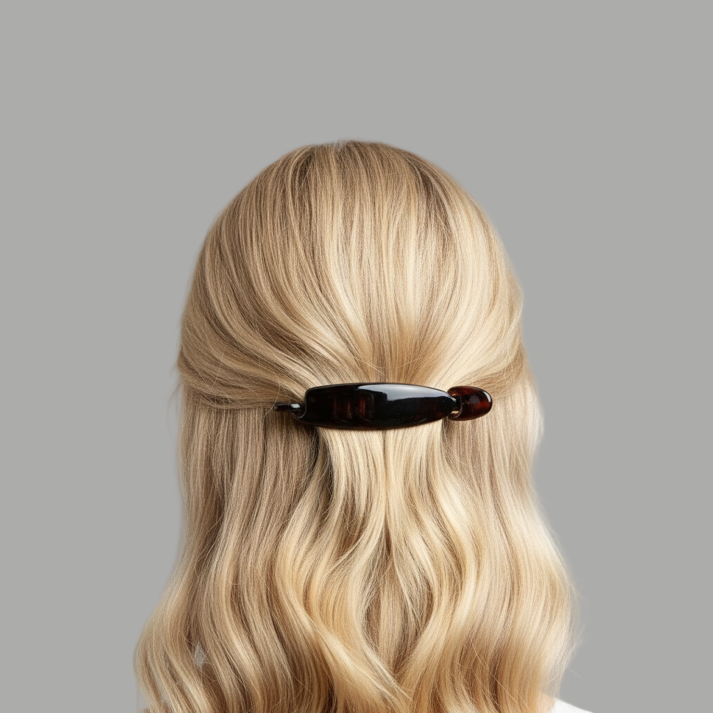 Blonde hair with a brown hair clip on a grey background