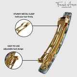 Gold hair clip with text highlighting features on a gray background