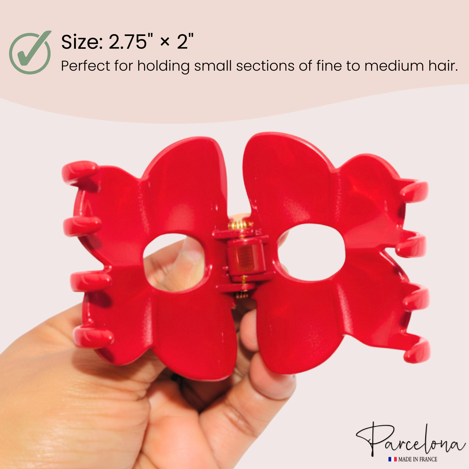 Red hair clip held by a hand with size and product information text overlay