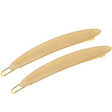 Two beige hair clips with gold hardware on a white background
