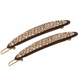 Two decorative hair clips with rhinestones on a white background