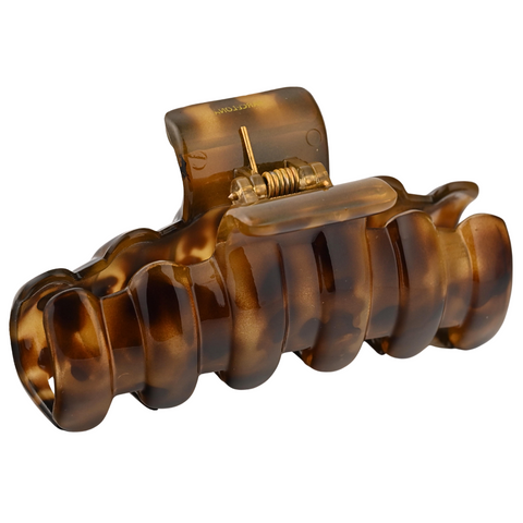 Brown tortoiseshell hair clip on a white background