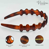 Close up of Parcelona acetate headband showing small inner teeth and printed logo