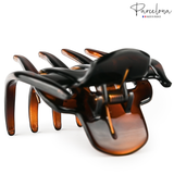 Top view of tortoise shell French hair claw showing spring hinge and acetate finish