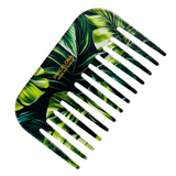Comb with green leaf pattern on a white background