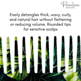 Hair detangling comb with green and black design on a white background, featuring text about its use.