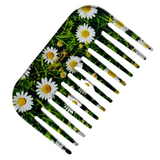Comb with daisy flower design on a green background
