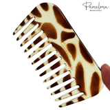 Giraffe-patterned comb with 'Parcelona' branding on a white background