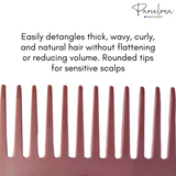 Pink comb with text about hair care on a white background