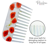 Hair comb with red flower design and 'Parcelona' branding on a white background