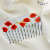 Hair comb with red poppy designs on a white background, featuring the 'Parcelona' brand.
