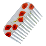 Hair comb with red poppy flower designs on a white background
